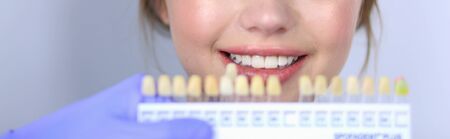 Dentist and patient sitting in dentist office.の写真素材
