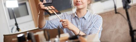 Female vlogger presenting make up tutorial videoの写真素材