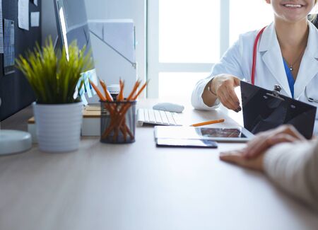A doctor is talking and examining a patient.の写真素材