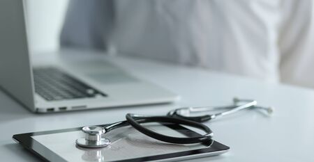 Medical equipment: blue stethoscope and tablet on white background. Medical equipment.の写真素材