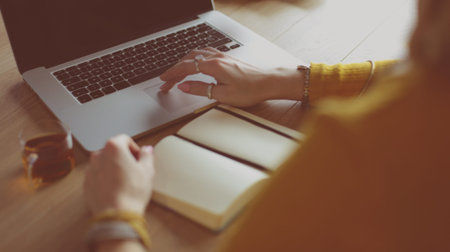 Young woman holding credit card and using laptop computer. Online shopping concept
