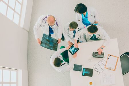 Medical team sitting and discussing at table, top viewの写真素材
