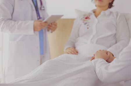 medical doctor holing senior patient's hands and comforting her.の写真素材