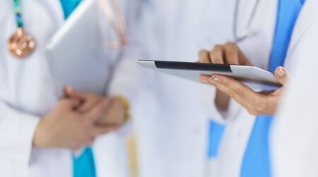 Group of doctors and nurses standing in the hospital room.の写真素材