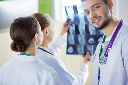 Medical doctors analysing x-ray photography in hospital