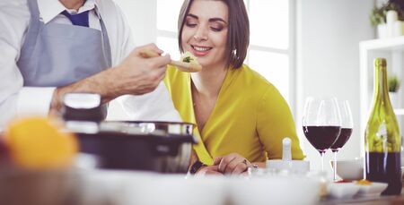 Couple cooking together in the kitchen at homeの写真素材