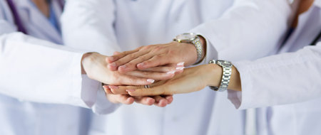 Doctors and nurses in a medical team stacking hands.の写真素材