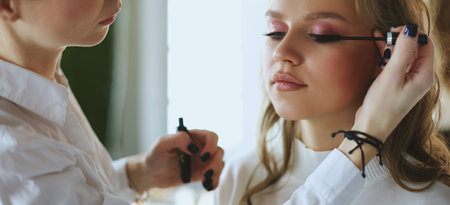 beautiful young model woman getting fashion make-up