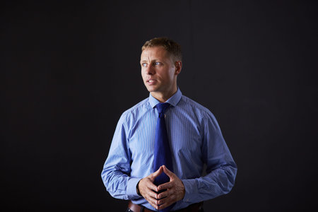 Portrait of successful businessman. Isolated on dark backgroundの写真素材