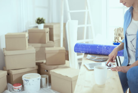 A beautiful single young woman unpacking boxes and moving into a new home