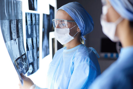 Two female women medical doctors looking at x-rays in a hospital