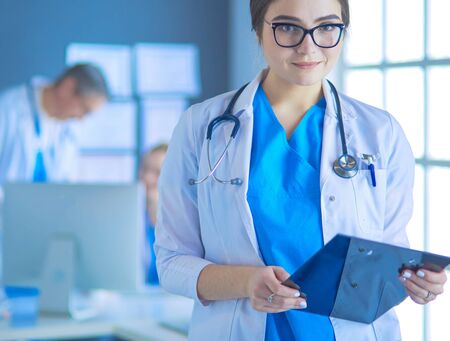 Female doctor using tablet computer in hospital lobbyの写真素材