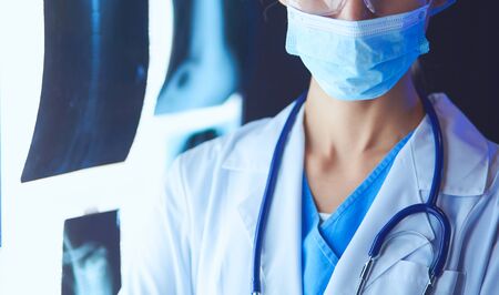 Image of attractive woman doctor looking at x-ray results.の写真素材