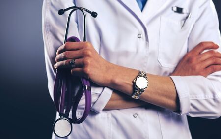 Portrait of young female doctor holding a stethoscopeの写真素材