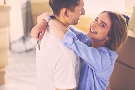 Happy smiling young couple showing a keys of their new houseの写真素材