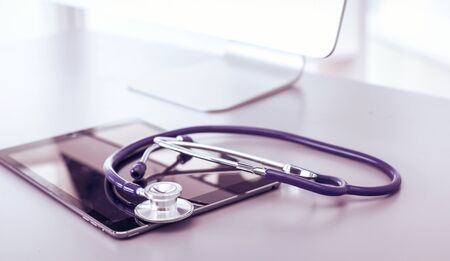 Medical equipment: blue stethoscope and tablet on white background. Medical equipmentの写真素材