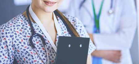 A medical team of doctors, man and woman, standing in office.の写真素材
