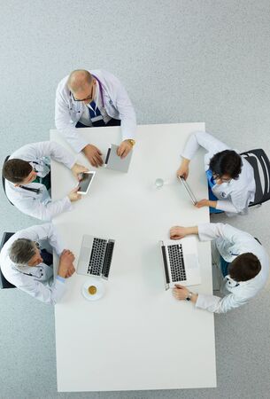 Medical team sitting and discussing at table, top view.の写真素材