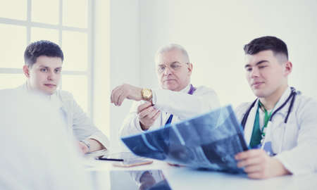 Medical team sitting and discussing at tableの写真素材