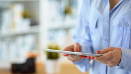 Portrait of an attractive professional photographer woman and using a tabletの写真素材