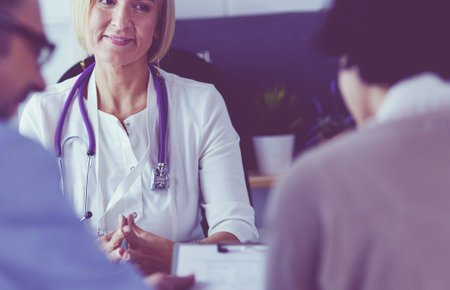 Portrait of senior doctor in office sitting at the desk