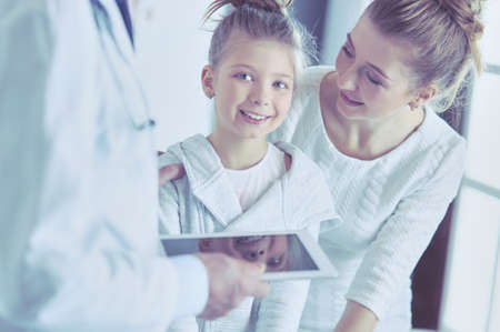Little girl with her mother at a doctor on consultationの写真素材