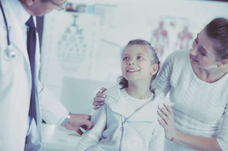 Little girl with her mother at a doctor on consultationの写真素材
