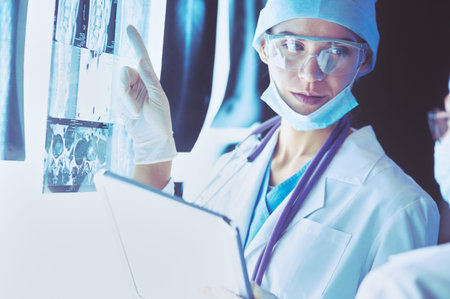 Two female women medical doctors looking at x-rays in a hospital.