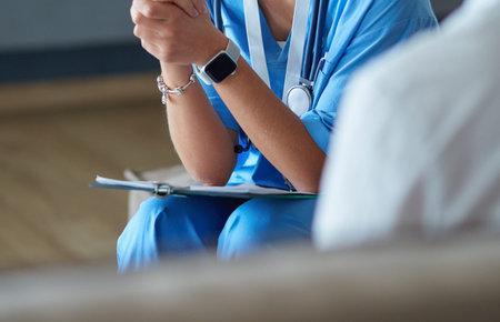 Female doctor hand hold silver pen filling patient history list at clipboard padの写真素材