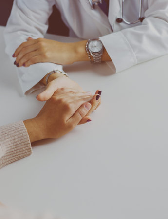 Woman doctor helping senior holding hand in hospitalの写真素材