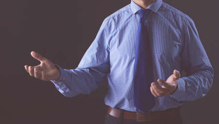 Image of two young businessmen interacting at meeting in officeの写真素材