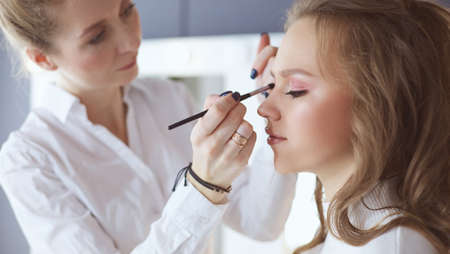 beautiful young model woman getting fashion make-upの写真素材