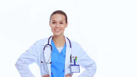 Beautiful young woman in white coat posing with hand in pocket. Woman doctor