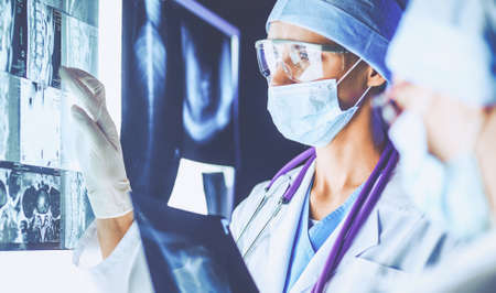 Two female women medical doctors looking at x-rays in a hospital.の写真素材