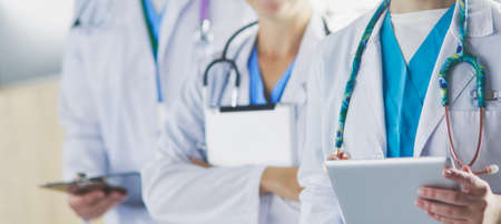 Group of doctors and nurses standing in the hospital roomの写真素材