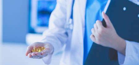 Close-up shot of doctors hands holding pills.の写真素材