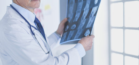 Male doctor writes notes on the clipboard in the hospital