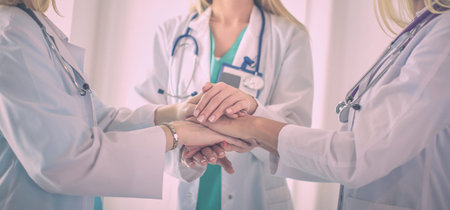 Doctors and nurses in a medical team stacking hands.の写真素材