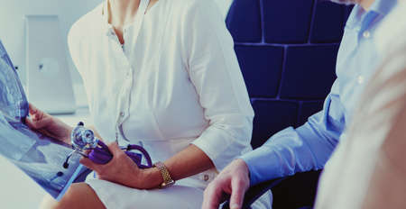 Medical doctor looking at a x-ray image in the officeの写真素材