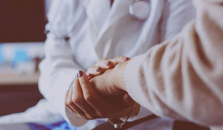 Doctor or nurse holding elderly ladys handsの写真素材