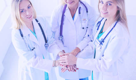 Doctors and nurses in a medical team stacking hands.の写真素材