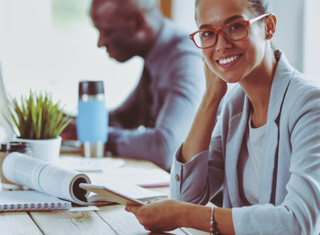 Business woman sitting in her office using a tablet computer. Business woman. Meeting