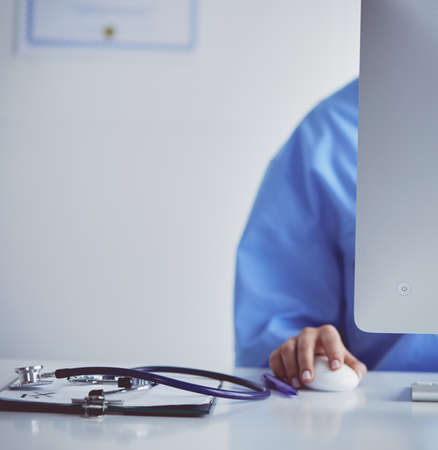 Female doctor sitting and working a laptopの写真素材
