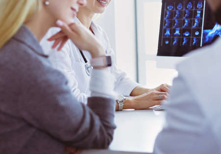 Doctor woman shows the patient chest x-rayの写真素材