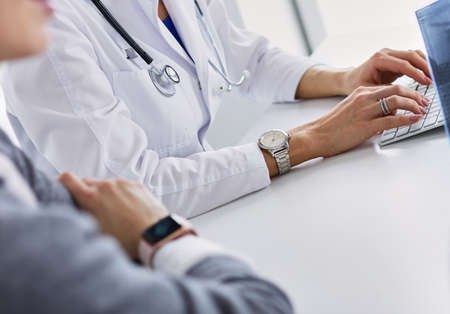 Doctor woman shows the patient chest x-rayの写真素材