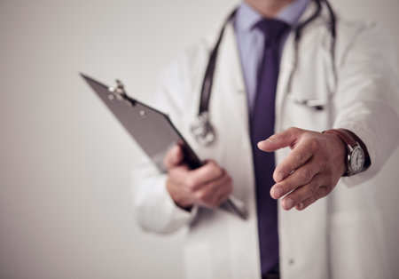 Friendly male doctor with open hand ready for huggingの写真素材