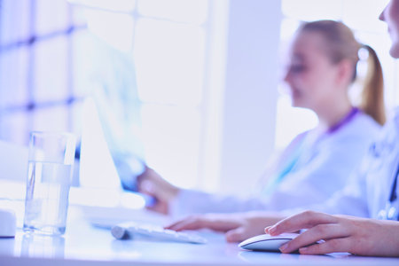 Two young female doctors working on computer at hospital.の写真素材