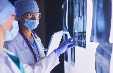 Two female women medical doctors looking at x-rays in a hospital.の写真素材