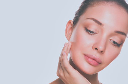 Close up portrait of beautiful young woman face. Isolated on white background.の写真素材