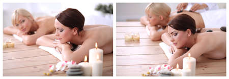 Two young beautiful women relaxing and enjoying at the spa centの写真素材